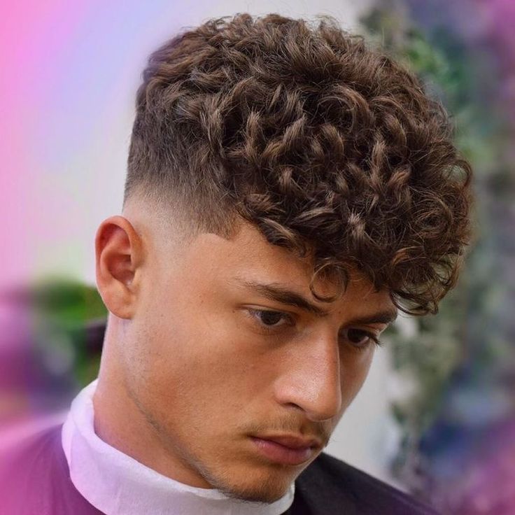 the image shows, Mid Drop Fade Curly Hair