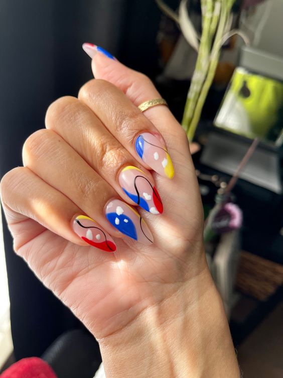 In this image show, the long blue and yellow with the abstract nails design.
