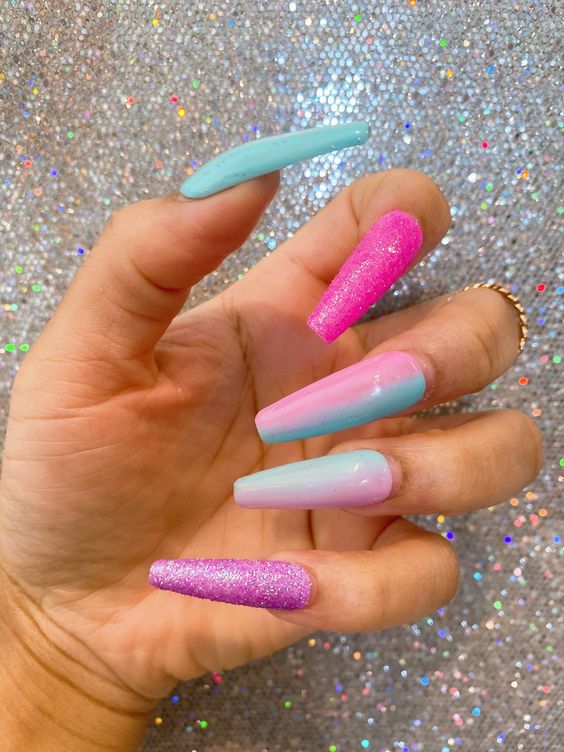 In this image show, the long cute blue glitter with pink combination of nails design.