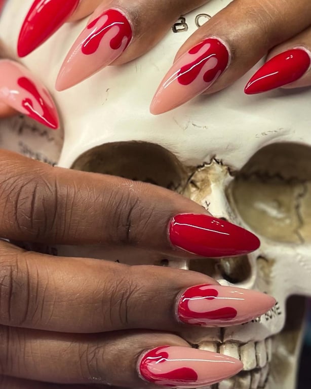 This image show, the red color blood droop nails halloween design.