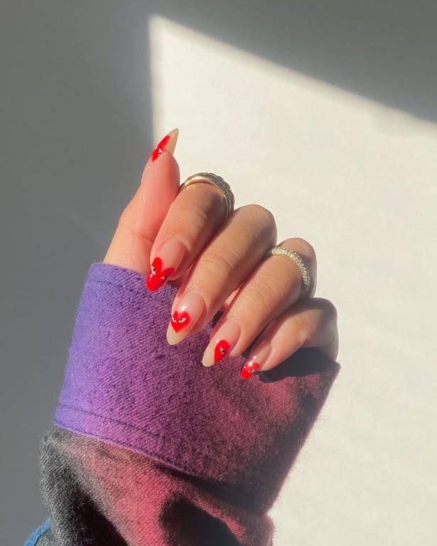 In this image show, the red color heart shape nails design.