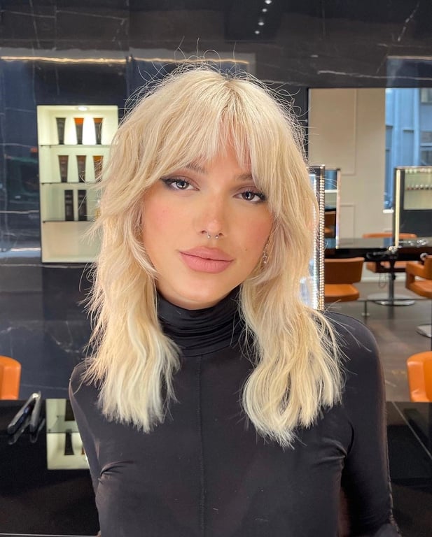the image shows, wolf cut mullet with curtain bangs