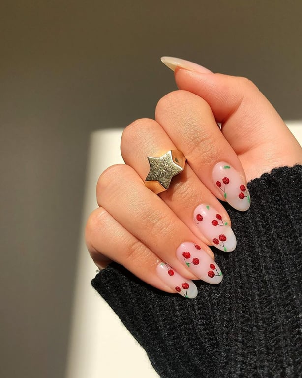 In this image show, the cute nude base coat with the ultra cute red charee nails design for this newyear nails design.