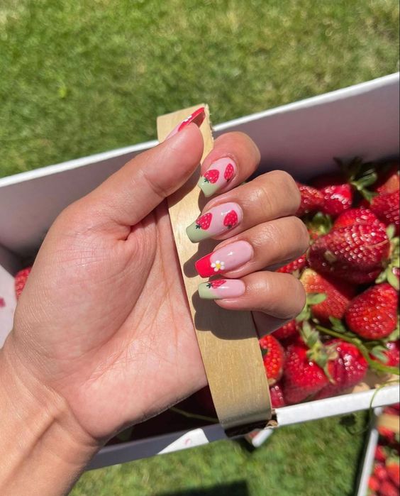 In this image show, the cute red color strawberry nails design are an spring perfect nails design.