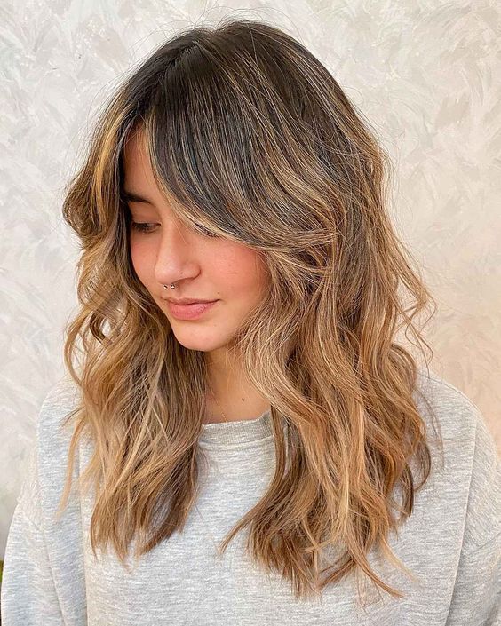 In this image show, the layered Wavy Curtain Bangs for Luscious Haircuts apply this for impress anyone.