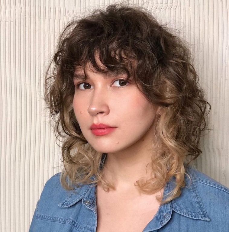 In this image show Wolf Cut With Curled Bangs 