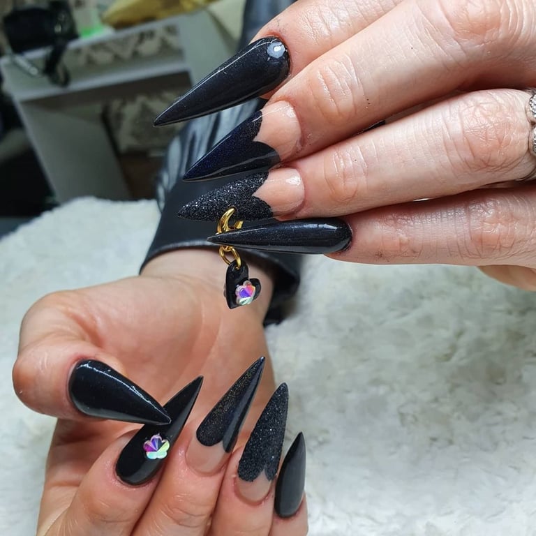 In this show the, black heart shape gothic nails design.