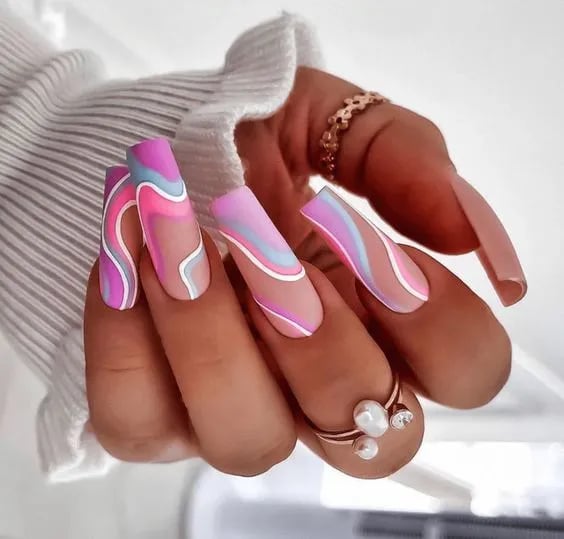 In this image show, the colorful rainbow swirls nails design.