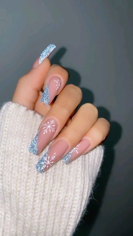 In this image, show the blue shnowflake nail design