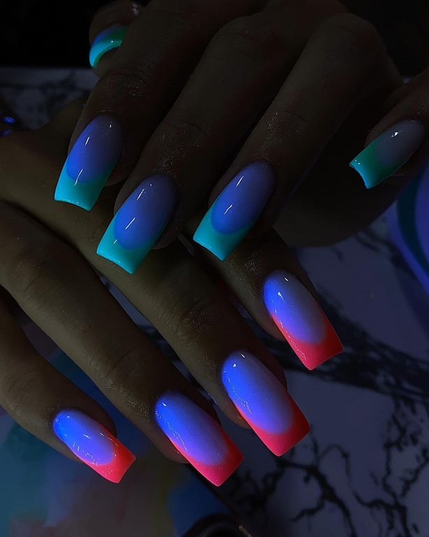 In this image show, the cute pink and blue with green bright glowing nails design.