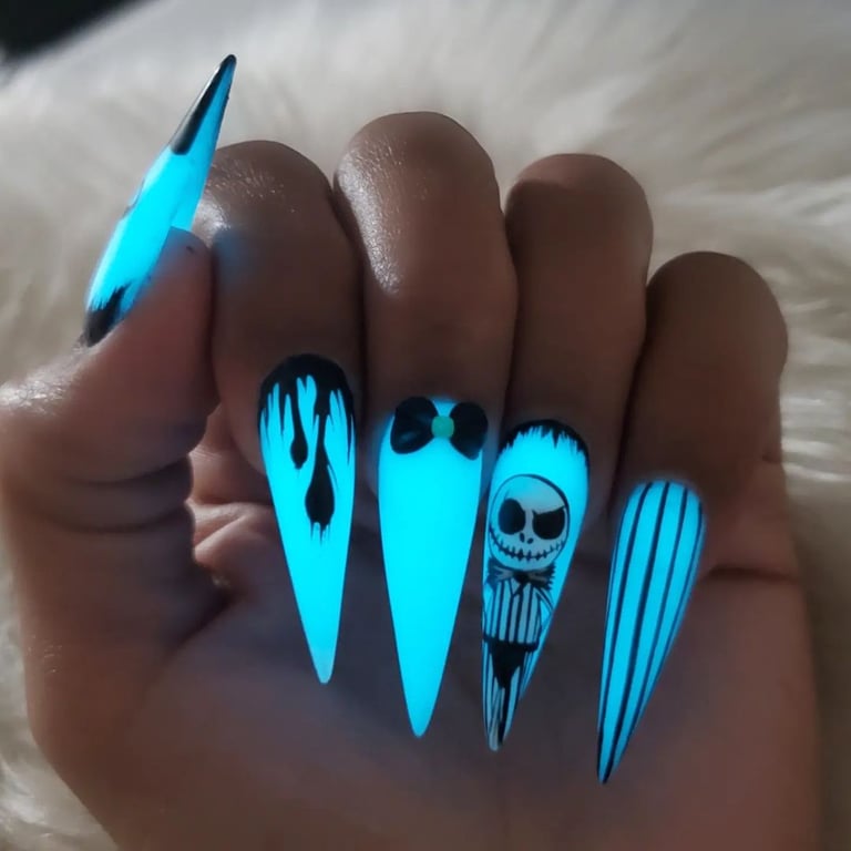 In this image show, the long litning blue nails design that are glow in the dark place.