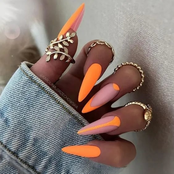 In this image show, the orange color long fall nails design.