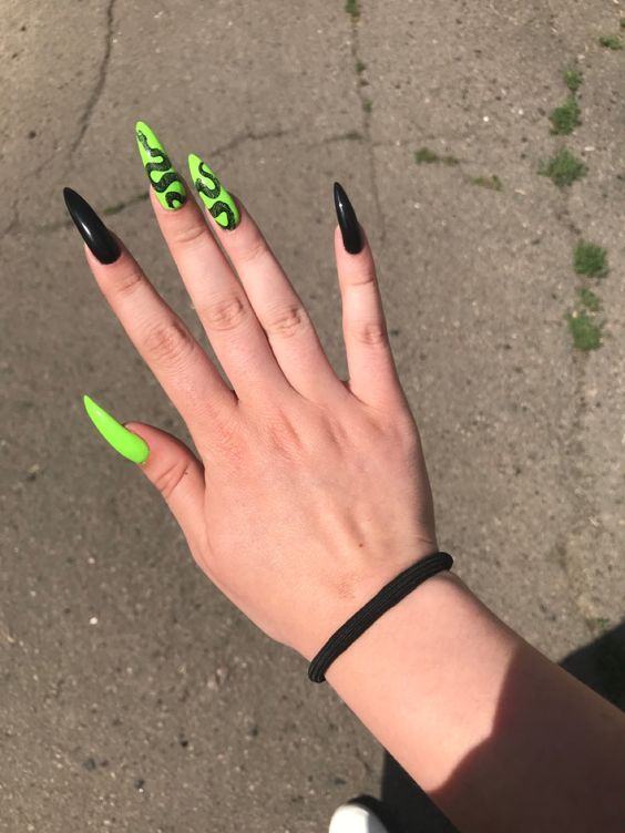 In this image show, the long black and neon color of this dargon nails designs.