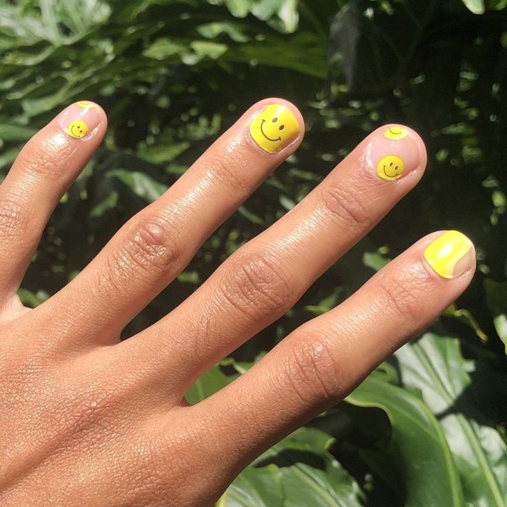 In this image show, the yellow color smiley nail design for man.