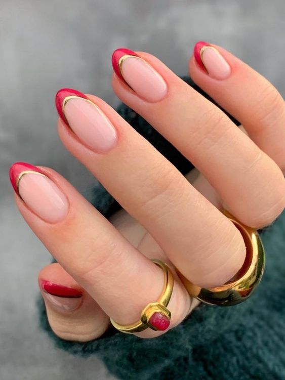 In this image show, the red and gold french tip of nails design.
