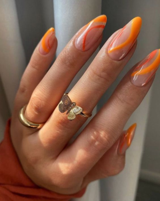 In this image show, the oval shape of nails with orange color.