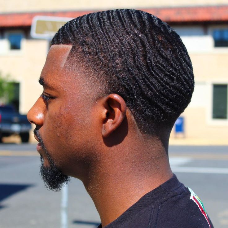 the image shows, taper haircut with waves