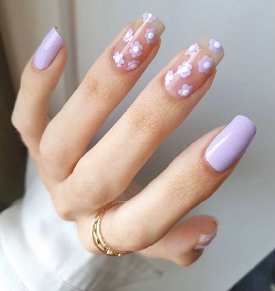 In this image show, the lavender with the white color short flower print nails design.