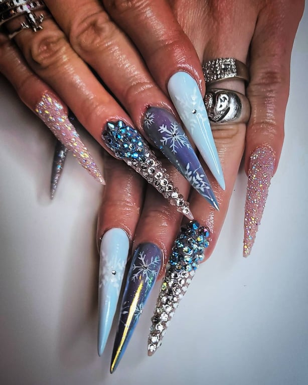 In this image show, the long with blue and add metallic Shine nails design.