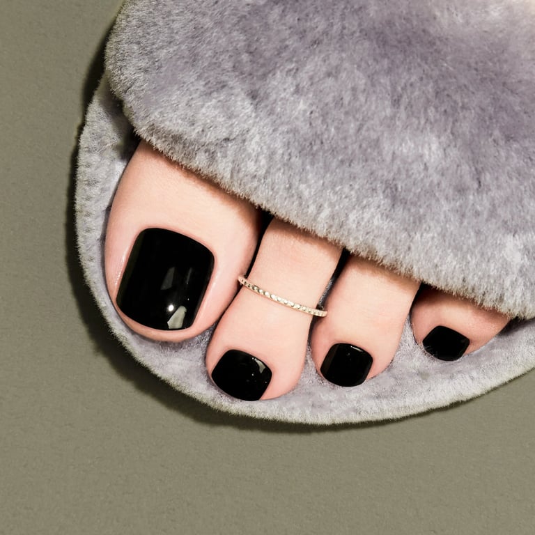 In this image show, the classy dark black toe nails design.