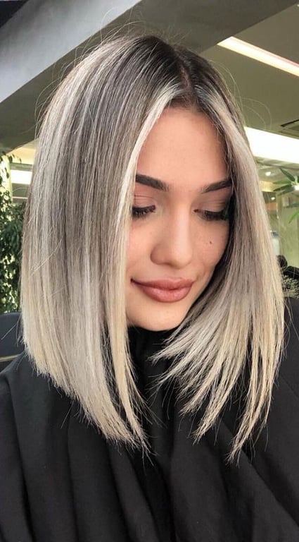 In this image show, the bold color with black roots fine hair color with this haircut Shoulder Length Haircuts for Thin Hair