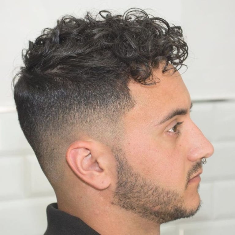 the image shows, high fade haircut curly hair