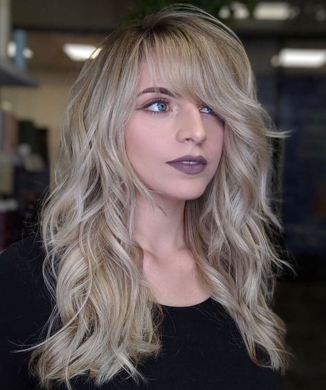 the image shows, deep side swept bangs with shag cut