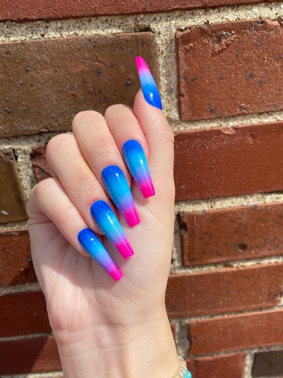 In this image show, the long pink and blue color with dark blue ombren nails design.