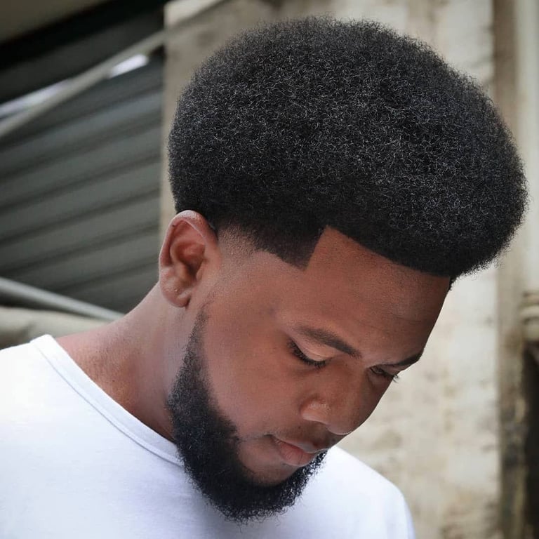the image shows, afro taper fade haircut