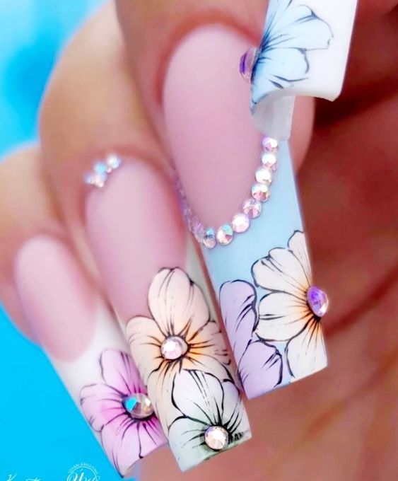 In this image show, the long cute pink and blue color of flower nails design.