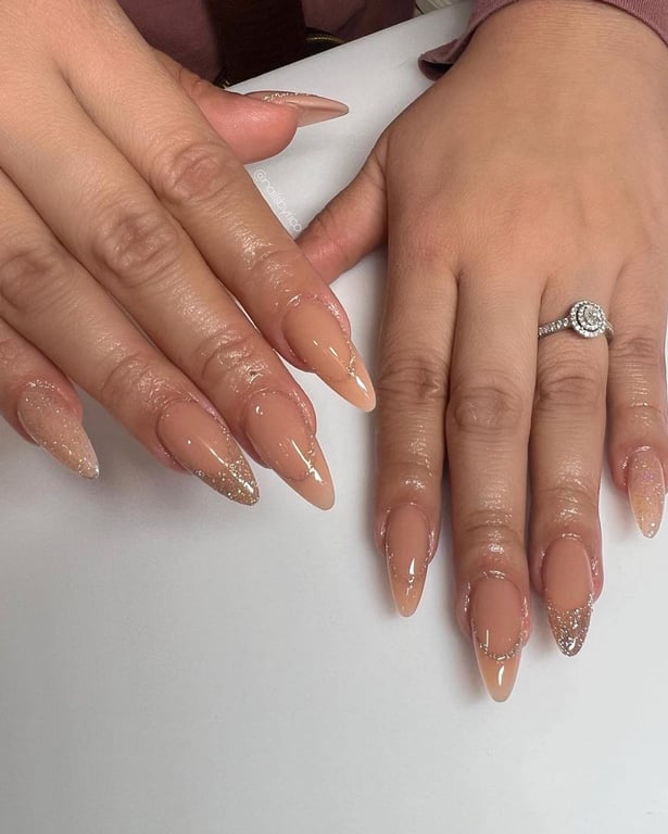 In this image show, the nude color with gliter acrylic nail design