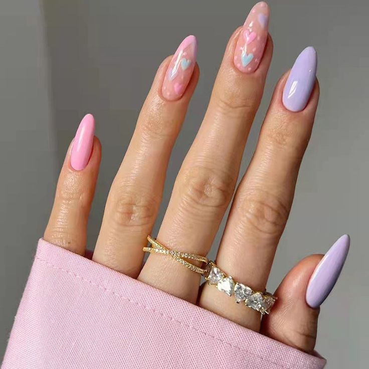 In this image show, the long pink and purple color hearts shape nails design.