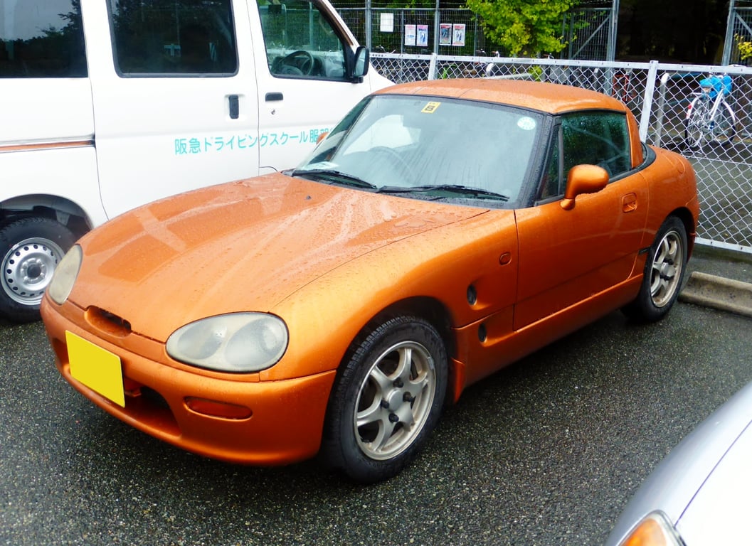 Orange Suzuki Cappuccino with the hardtop fitted, front three-quarter view