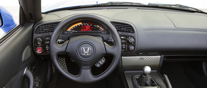 2004 Honda S2000 AP2 interior, driver-side view of dash, digital cluster, and 6-speed shifter