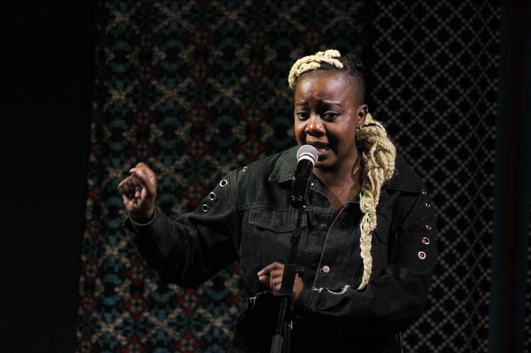 Bhanshee performing _Defiance_ at Word Kalcha Poetry Slam 2025