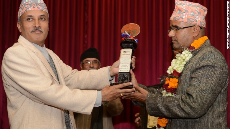 Nepalese civil servant Gyan Mani Nepal receives the inaugural Integrity Idol trophy for 2014.