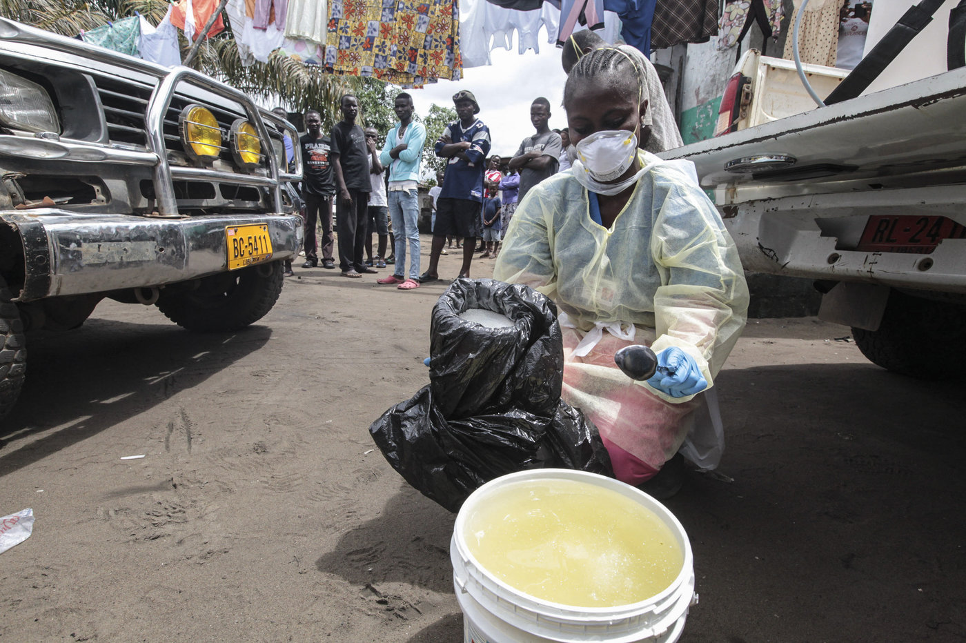 Garmai Sumo mixes chlorine with water to disinfect a residential area in Monrovia, Liberia, where a resident died of Ebola on Oct. 14, 2014. Garmai Sumo mixes chlorine with water to disinfect a residential area in Monrovia, Liberia, where a resident died of Ebola on Oct. 14, 2014.