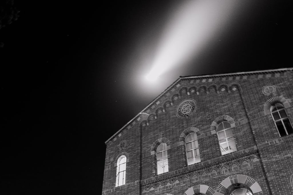 A light can be seen over a building at UCLA, most likely a police spotlight. 