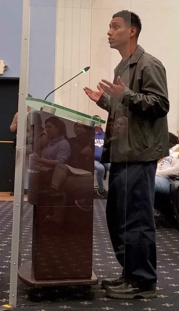 Jonathan Fajardo speaks at podium during Compton City Council meeting public comment.