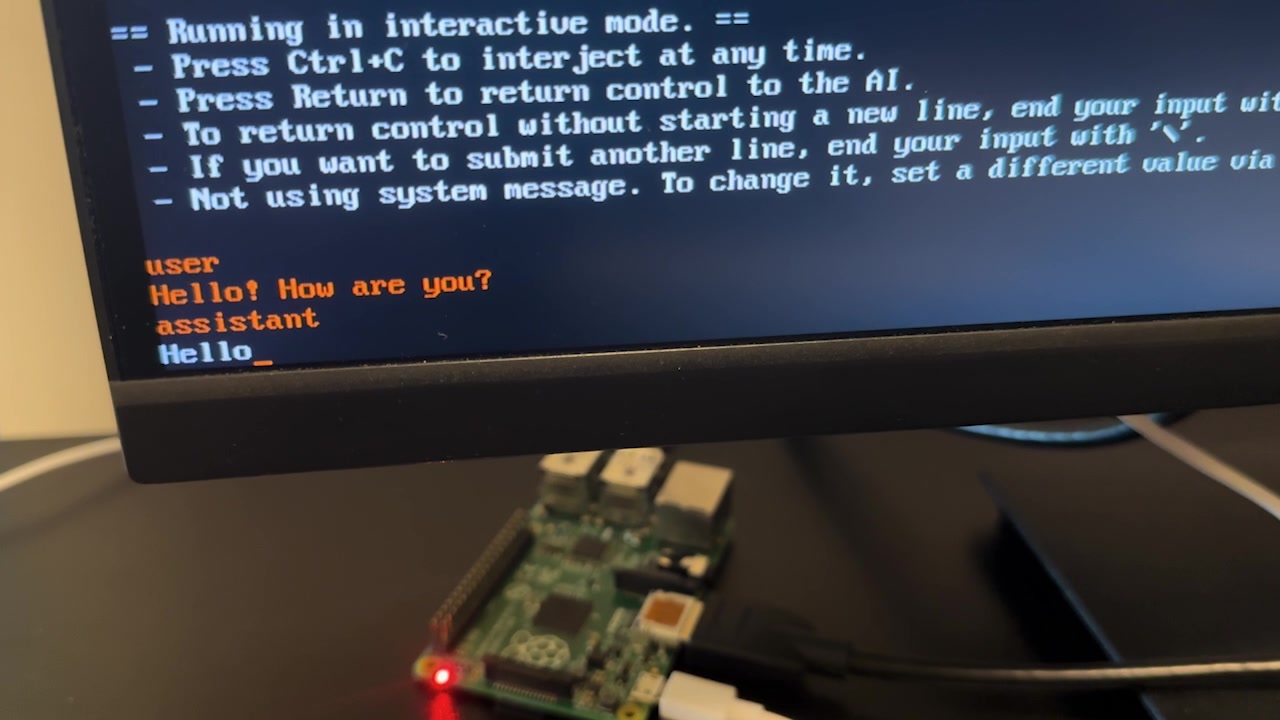 Terminal on a monitor with the Raspberry Pi in the foreground successfully generating a coherent response with the 4-bit model