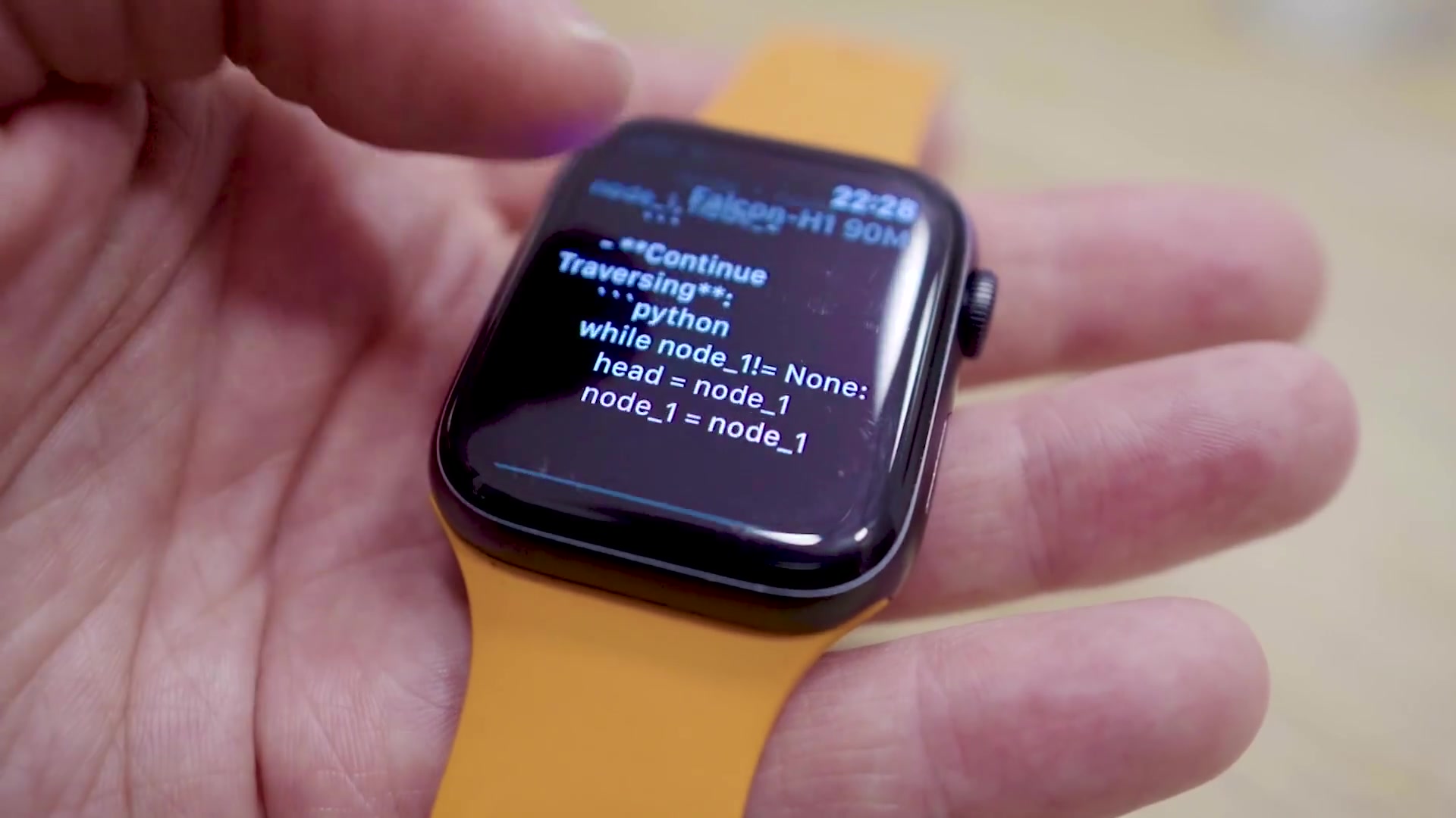 A close-up of the Apple Watch displaying performance metrics like "tokens/sec", "peak memory", and "kv cache" overlaid on the generated text.