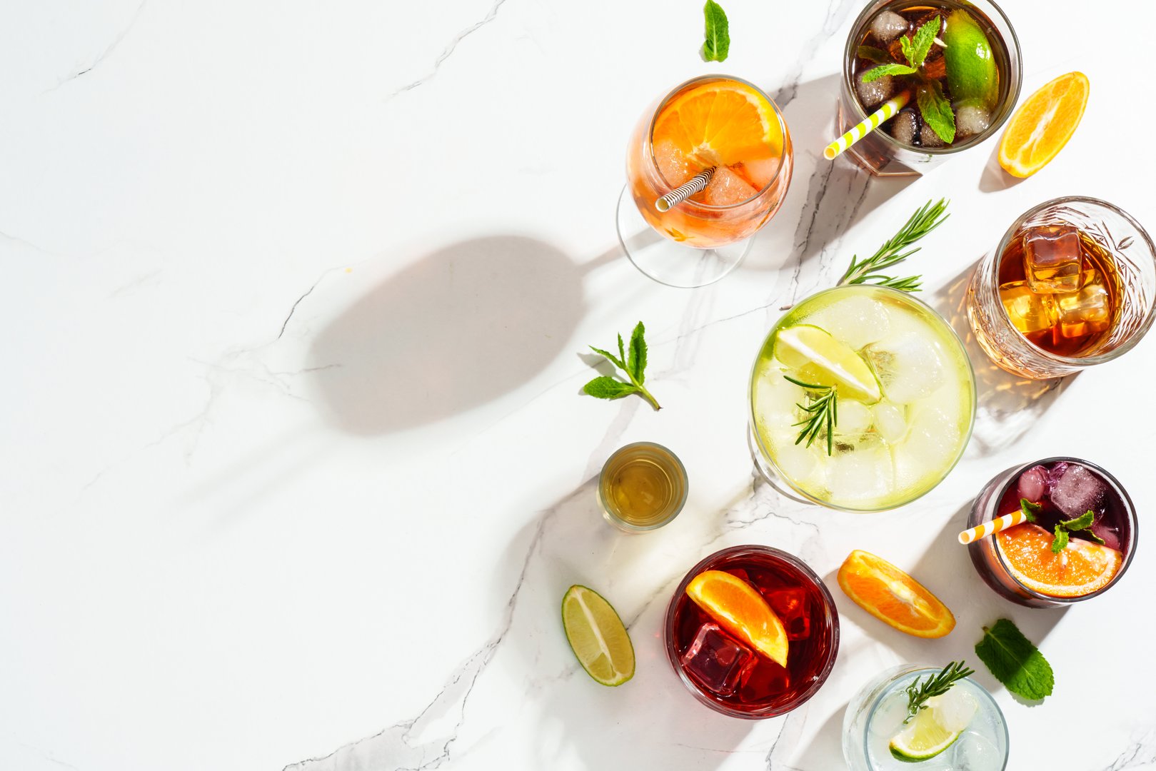 Cocktail party, Alcohol cocktail drinks. Whiskey, margarita, Spritz, Cuba libre, red wine, negroni, sangria and jin tonic at white background. Top view with copy space.