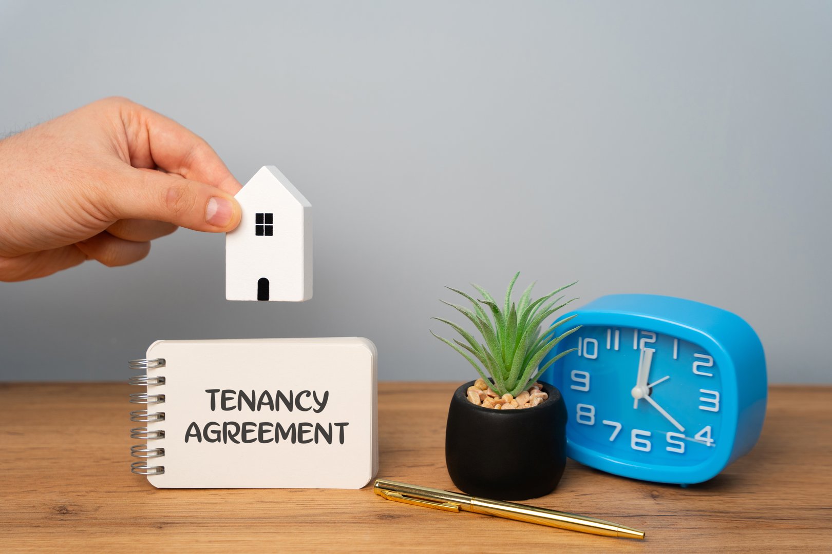 Tenancy agreement concept. Legally binding contract between a landlord and a tenant, outlining the terms and conditions under which the tenant can occupy the property. Notes and house with man