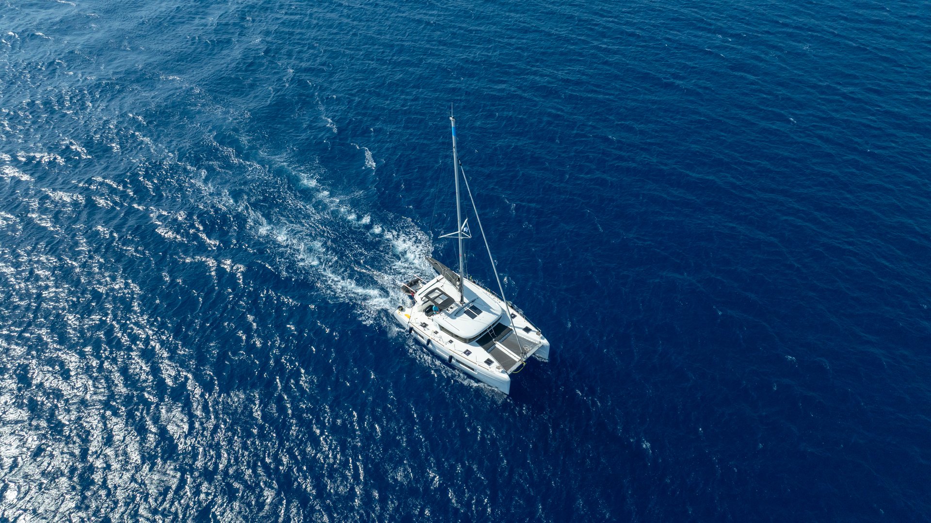 A sleek catamaran sailing across the clear blue waters, offering a smooth and relaxing ride on the open sea.