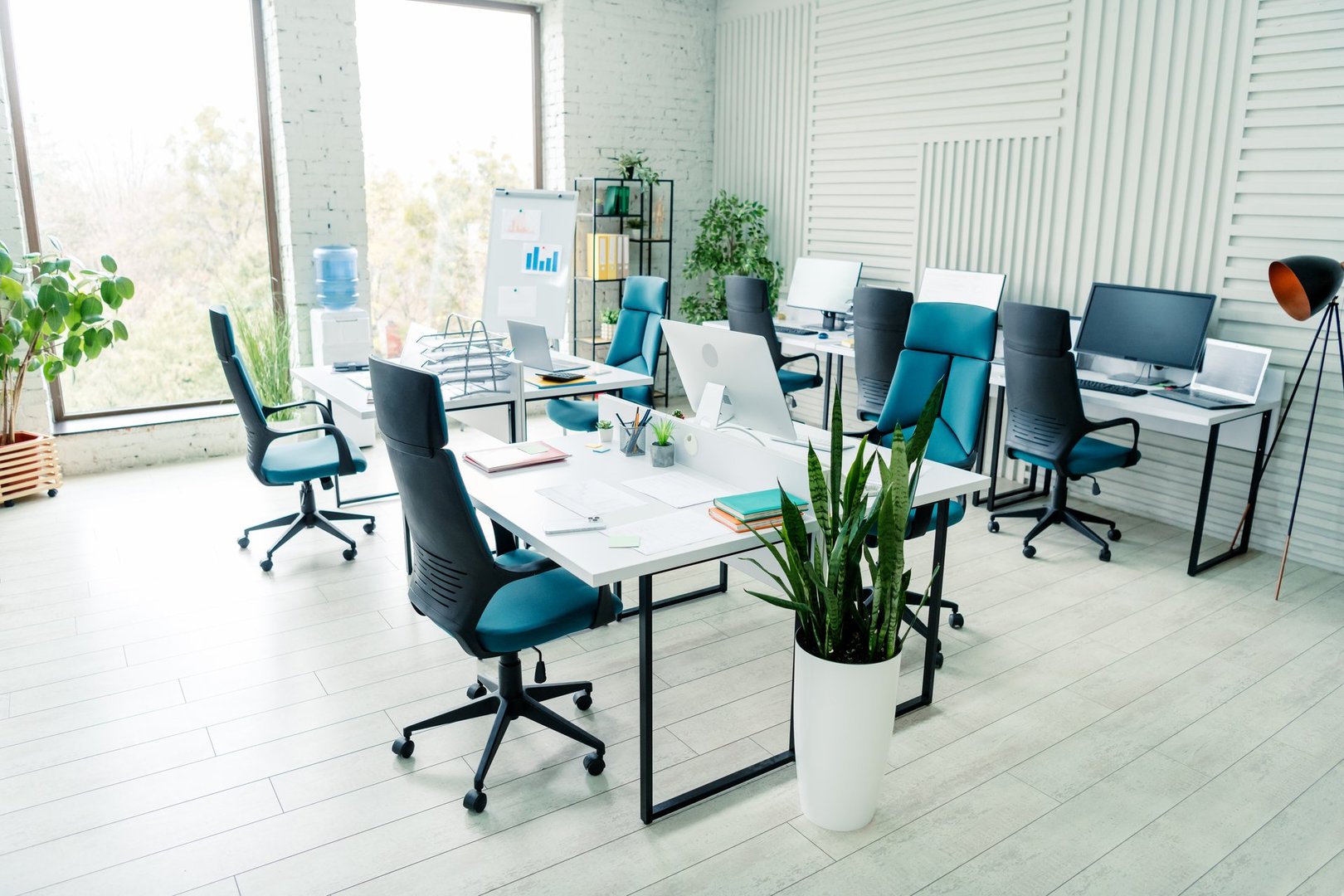 Modern coworking space with stylish office interior featuring desks, chairs, and natural lighting for collaborative work