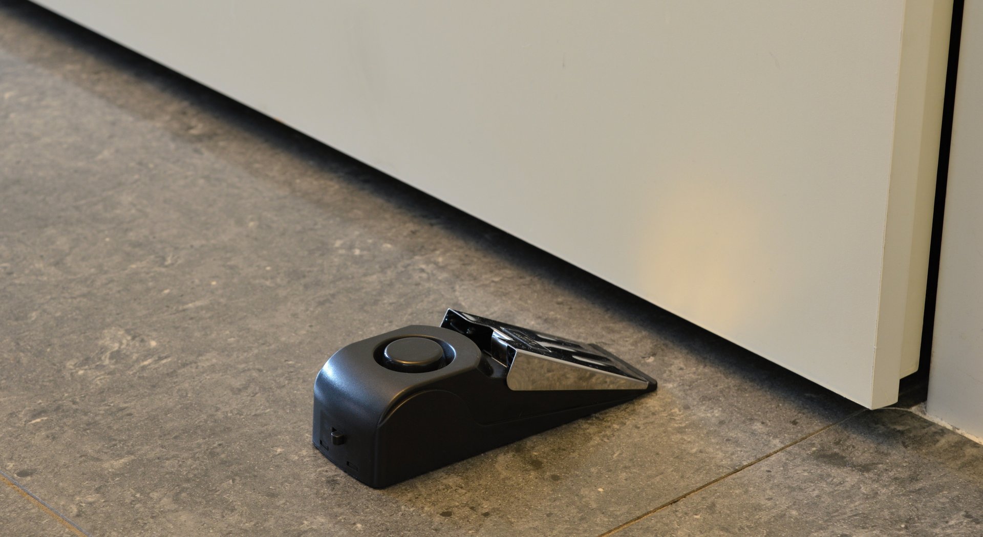 Mobile door alarm placed behind a door.