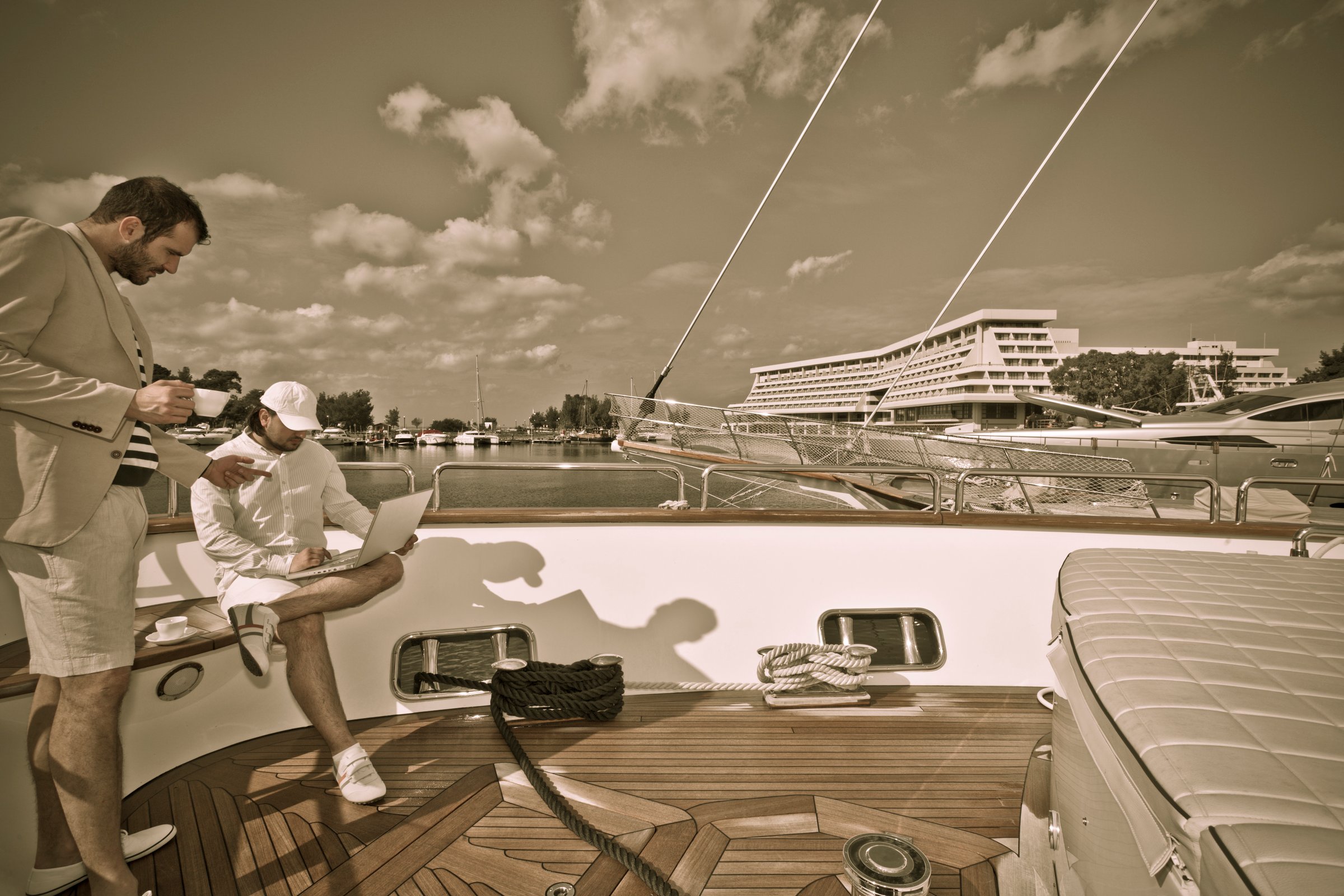 Young businessman dooing business on board a luxury yacht. Aged photoMore like this