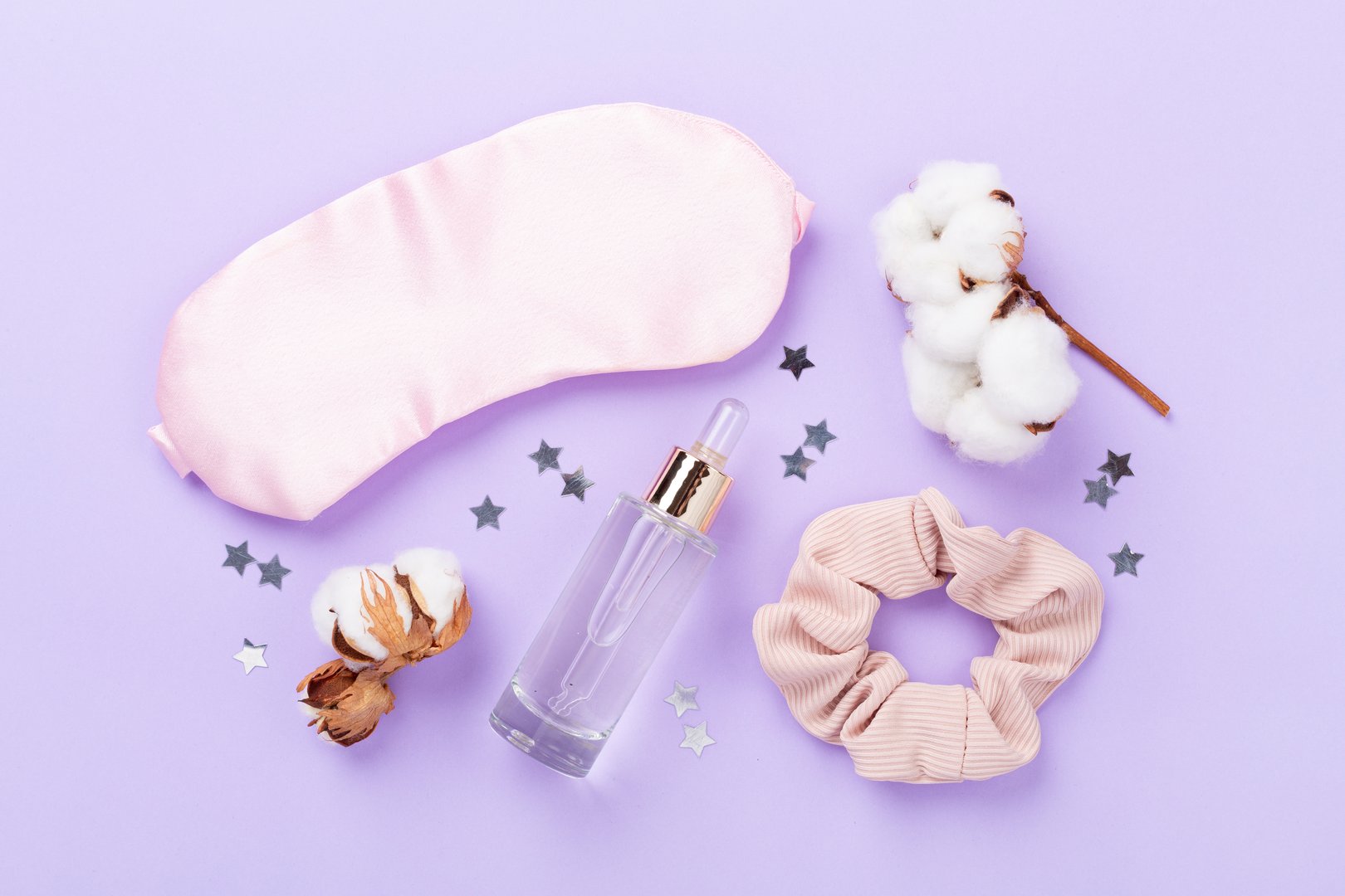 Sleeping mask with accessories on color background, top view. Sleeping routine concept