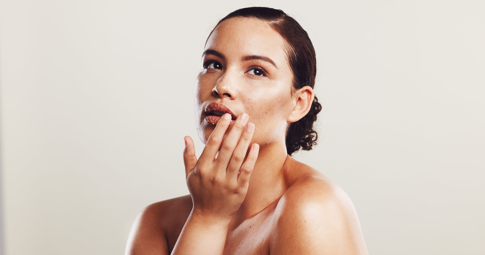 Beauty, skincare and woman with cosmetics, shine and dermatology on white studio background. Person, mockup space and model with confidence, wellness and healthy skin with acne treatment and glow