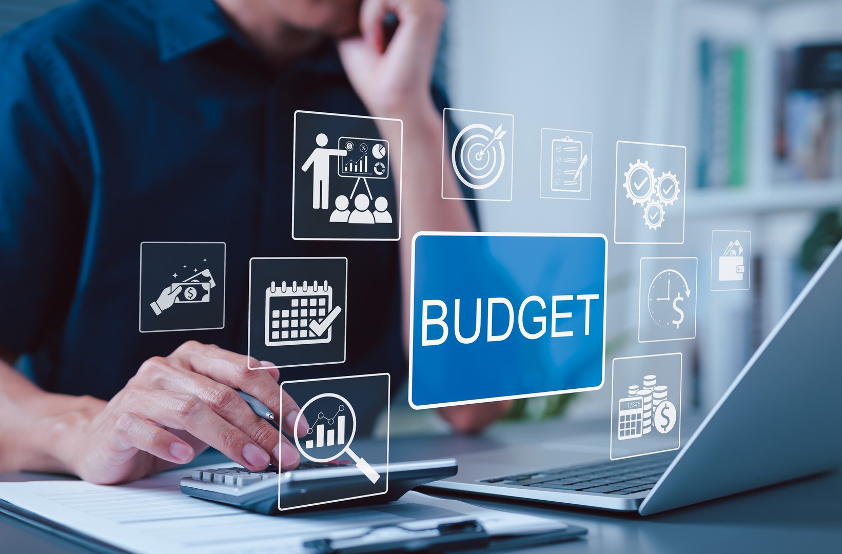 Budget and Financial Planning Concept. Businessman using calculator and laptop with icons representing budgeting, financial management, planning, annual expenses, personal budget, economic strategy,